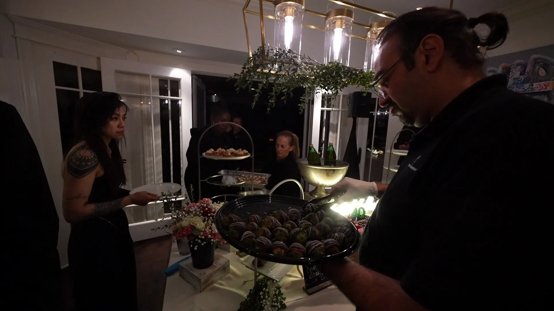 Catering staff presenting a tray of chocolate truffles at a Milpitas event