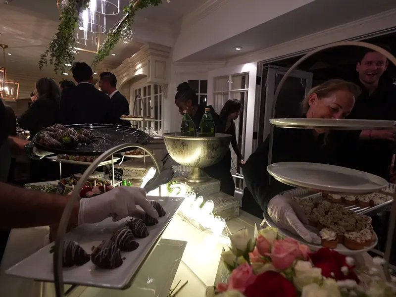 Tiered dessert and appetizer stands trimmed with fresh florals at a Fremont party