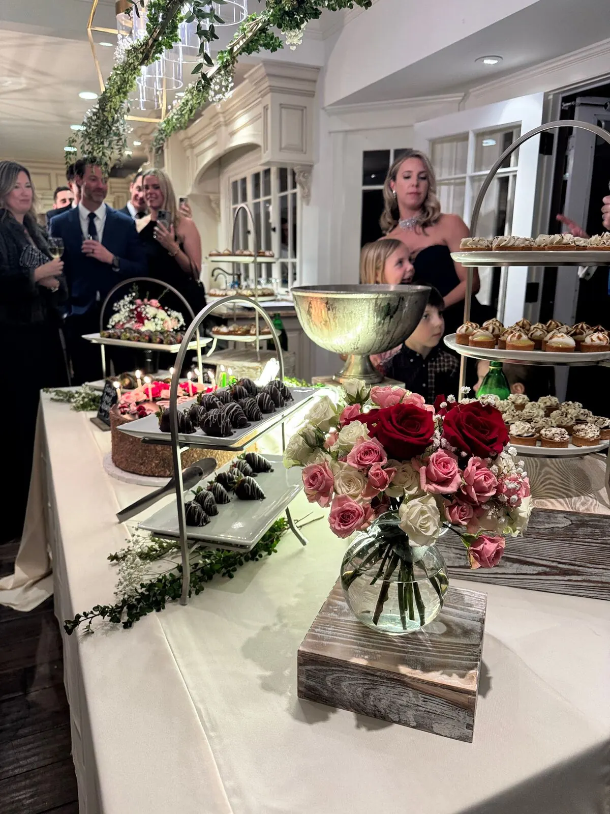 Dessert station with chocolate-covered strawberries, roses, and sweets at a Fremont reception